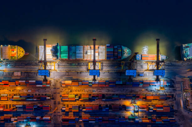 istock Containers yard in port congestion with ship vessels are loading and discharging operations of the transhipments in international port. 878422880