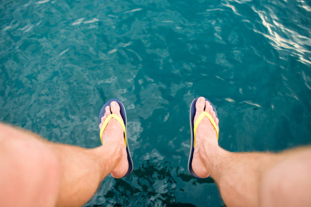 istock man legs hang from the pier 878422978
