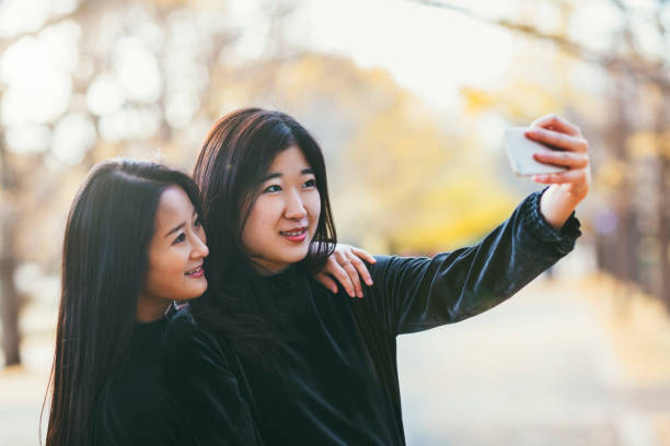 istock Friends Enjoying Taking Selfie In Autumn 878423050