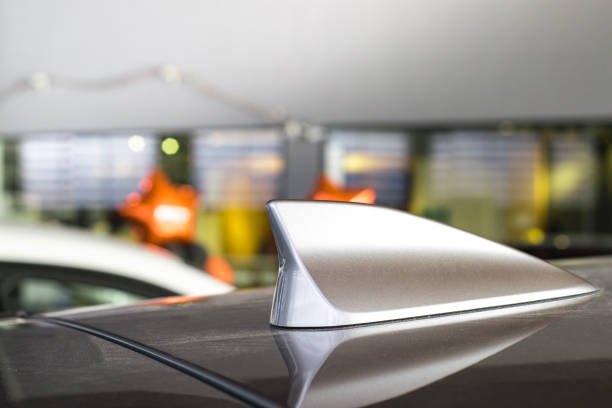 istock antenna shark fin white color on blurry backgorund. Using wallpaper or background.this car, automotive, transport image. 878426614