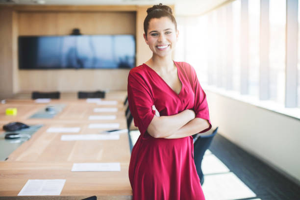 istock Female professional standing with arms crossed 878427266