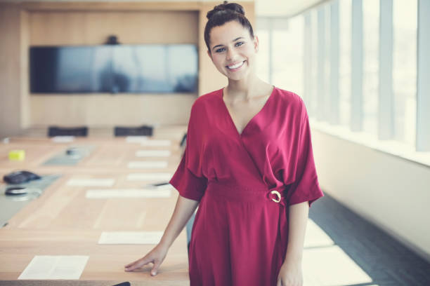 istock Confident young businesswoman standing at office 878427272