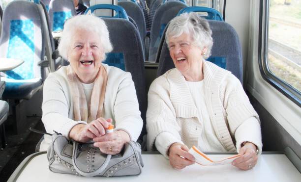 istock two senior women on train journey 878429390