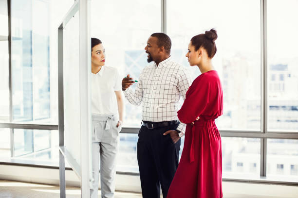 istock Mutli-ethnic colleagues discussing in board room 878429426