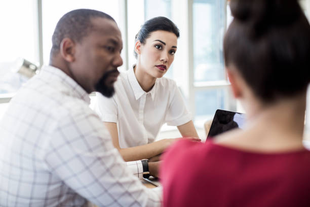istock Professionals discussing in board room at office 878429564