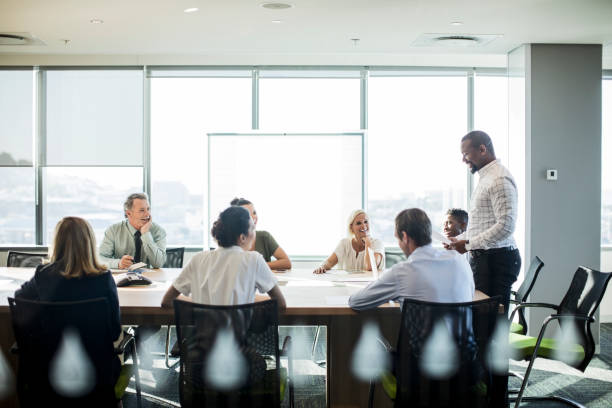 istock Multi-ethnic coworkers discussing at office 878439786