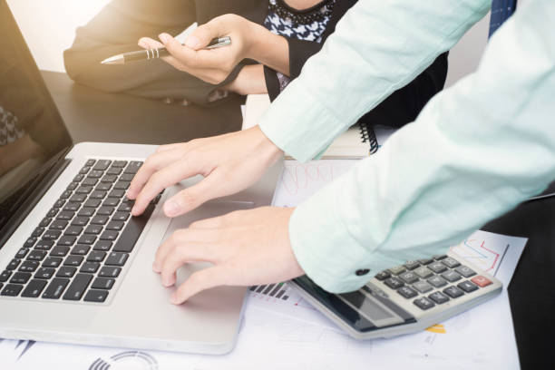 istock business accountant with document graph financial on office table. concept planning budget and audit. 878443754