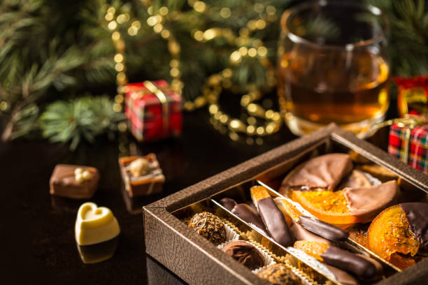 istock Chocolate candy, candied citrus, oranges with Christmas symbols 878447524