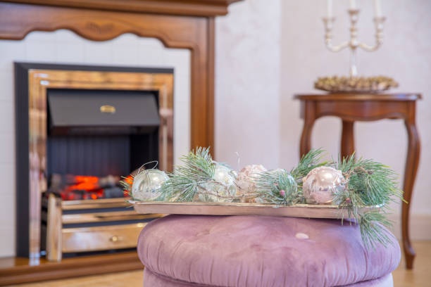 istock Christmas decorations on pouf  background of  fireplace 878450194