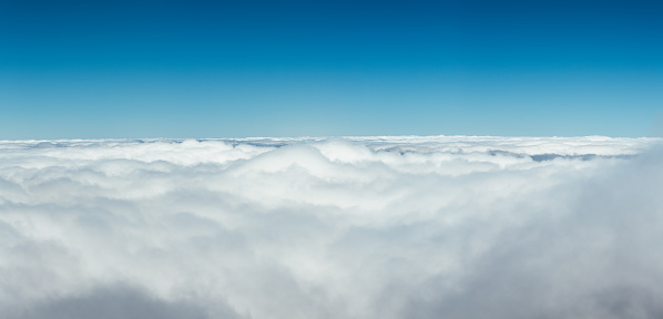 High above white fluffy clouds.