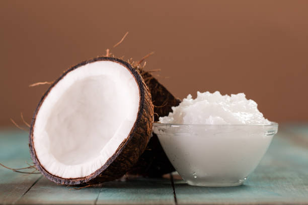 istock coconut oil and fresh coconuts on old wooden table 878460630