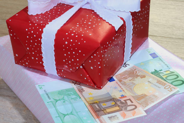 istock Christmas gifts with banknotes Euro 878460962
