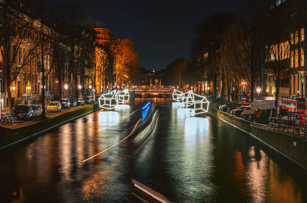 Amsterdam, Netherlands – January 5, 2017: Cottages of light float above the canal during the Festival of Light in Amsterdam