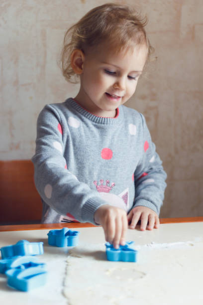 istock A little girl is preparing cookies. 878463908