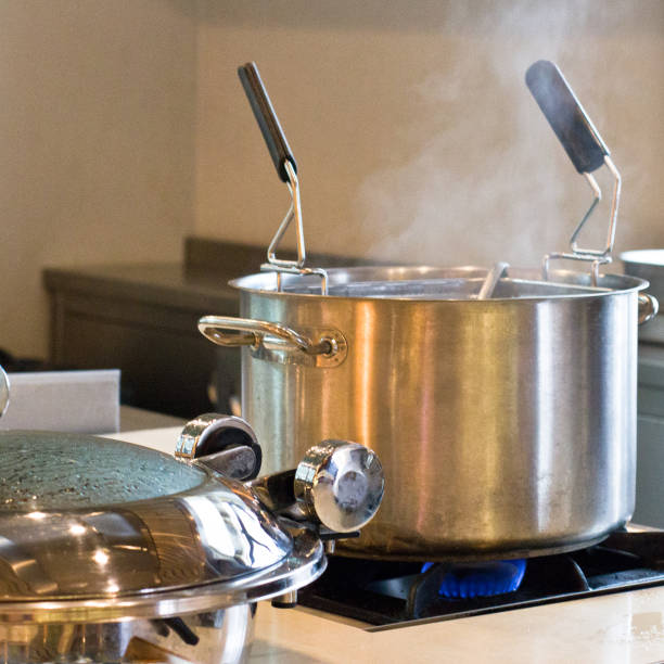 istock Large metal saucepan on the gas fire 878464042