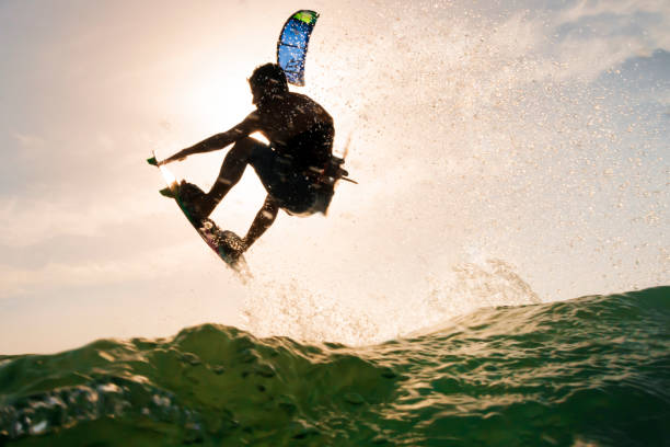 istock Surfer jumping in front of the sunset 878464140