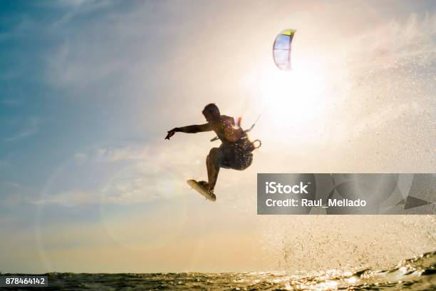 Surfer Flying In Front Of The Sunset Stock Photo - Download Image Now - Kiteboarding, Flying, Spain