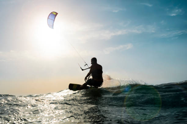 istock Kite surfer sailing in front of the sunset 878464152
