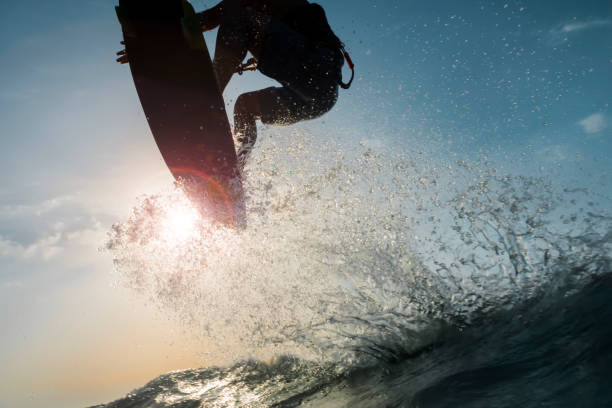 istock Surfer splashing and touching the sun 878464172