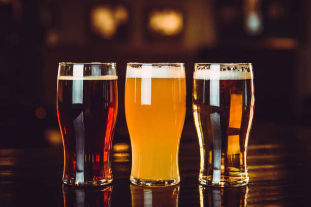 istock Glasses of light and dark beer on a pub background 878464670