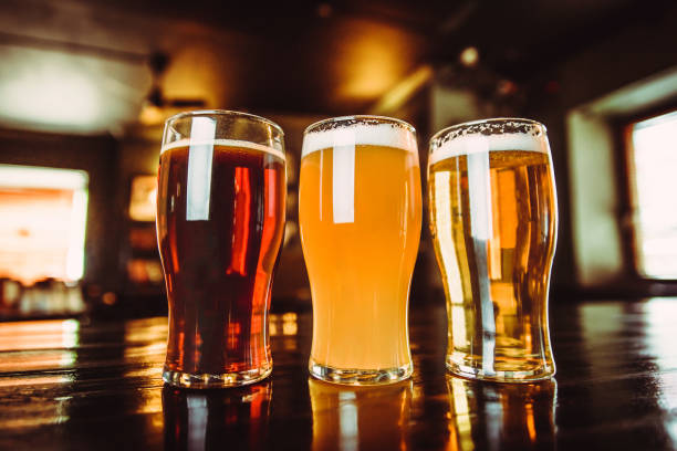 istock Glasses of light and dark beer on a pub background 878464792