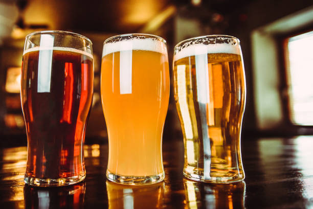 istock Glasses of light and dark beer on a pub background 878464864