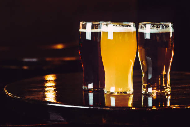 istock Glasses of light and dark beer on a pub background 878465004