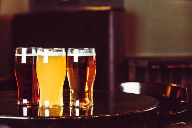 istock Glasses of light and dark beer on a pub background 878465046