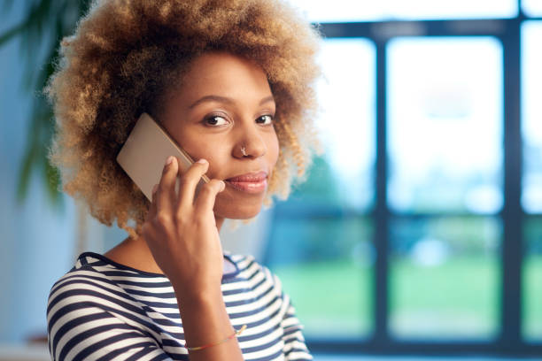 istock Young woman talking on her mobile phone 878468244