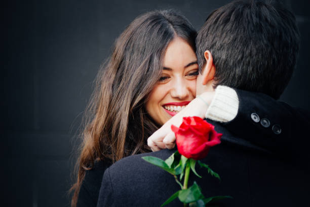 istock Beautiful couple in love with a rose 878474652