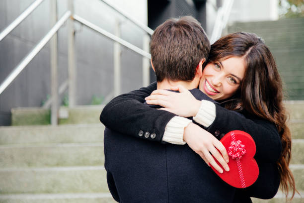Happy young couples holding the gift box