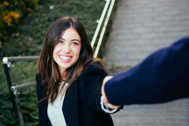 istock Couple in love holding hands on stairs 878477164