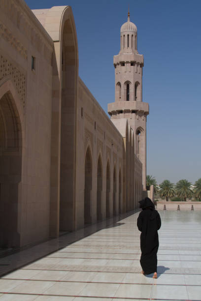 istock Lady in abaya at Sultan Quaboos Mosque. 878482202
