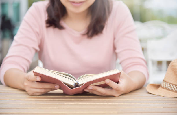 istock Happy Beautiful Asian Woman reading a book. 878493518