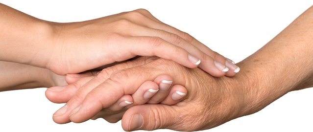 Young Woman's Hands Touching and Holding an Old Woman's Hand