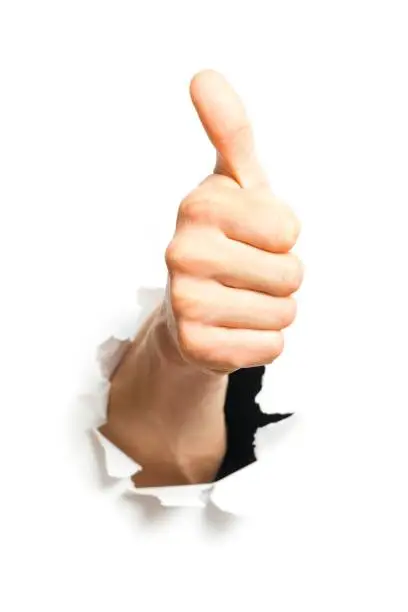 Thumbs Up Through A Hole In A Paper Sheet