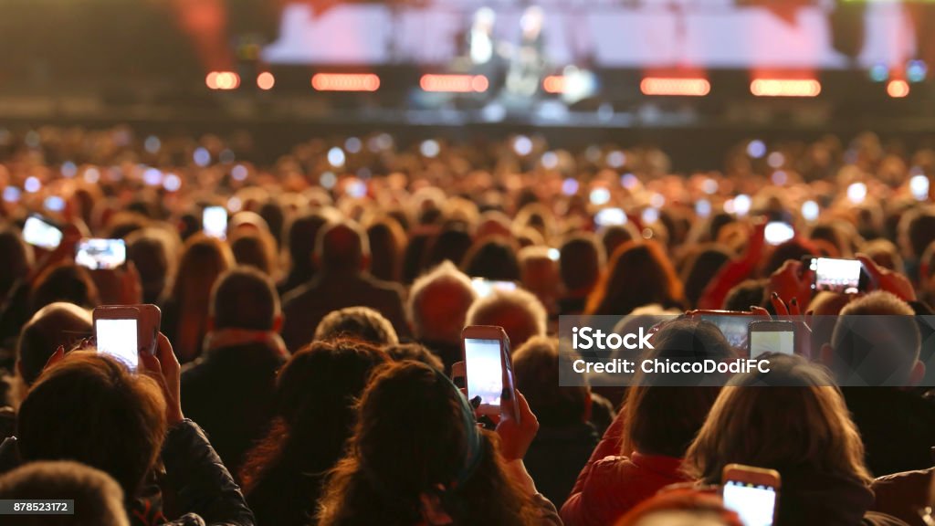 many people with smart phones at live concert many young people with smart phones at live concert Concert Stock Photo