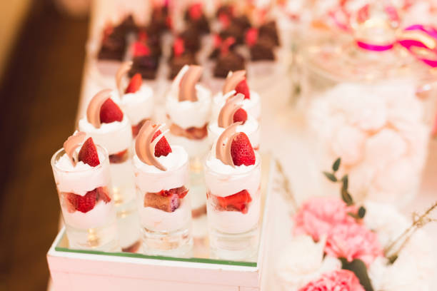 istock Delicious and tasty dessert table with cupcakes shots at reception closeup 878533588