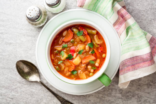 istock Italian minestrone soup in bowl on gray stone background 878534208