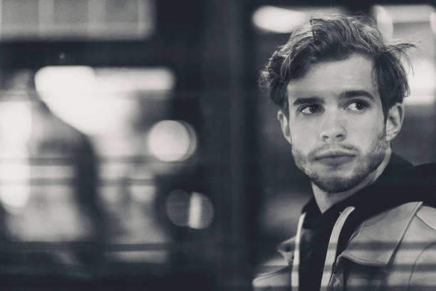 A young man in the city at night
