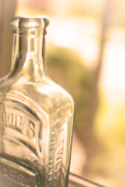 istock Glass Liquor Bottle sitting beside the Window Sill 878544318