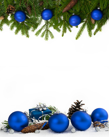Christmas decoration  four-fifths with blue baubles, cones and gift on white background.
