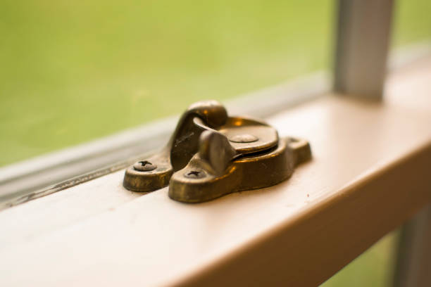 Window lock of a window A close up of a window look on a house window. window latch stock pictures, royalty-free photos & images