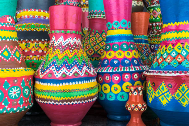 istock Stack of artistic painted colorful handcrafted pottery vases 878547746