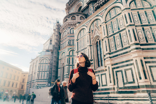 Woman walking on the streets of Florence near The Cattedrale di Santa Maria del Fiore, Italy