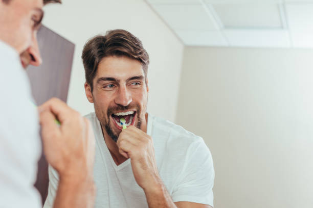 istock Man brushing teeth in the bathroom 878562274
