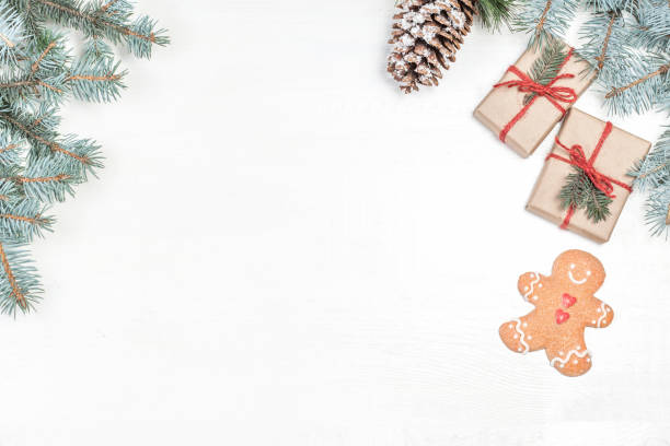 istock Christmas background with holiday decoration elements, presents  and fir tree branches on white wooden background. Christmas Flat lay  and top view composition with border and empty copy space 