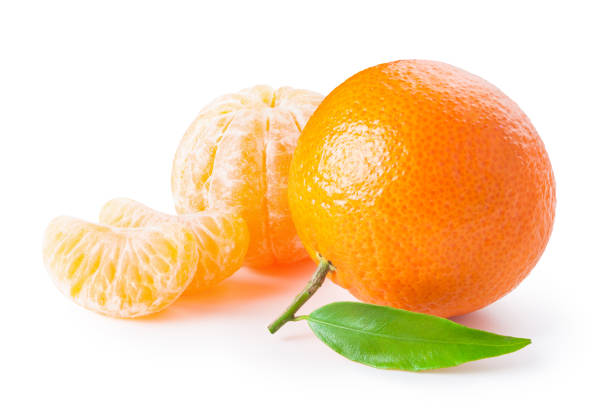 istock Tangerine or clementine with green leaf and slices isolated on white 878566344