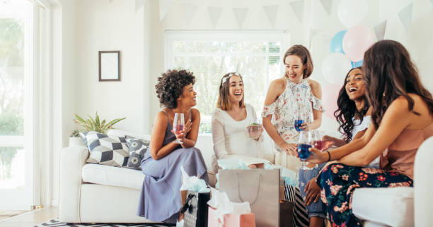 istock Female friends having drinks at baby shower 878570558