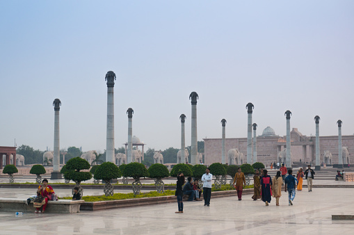 Lucknow, India - 16th Nov 2017: Families walking past the pillars and gardens of the famous Ambedkar park in lucknow. This is a popular hang out spot for locals and tourists alike